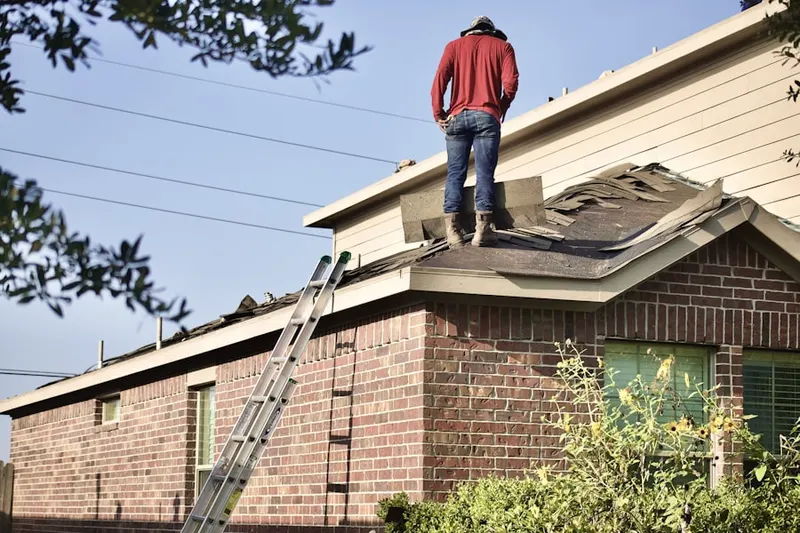 Professional roofer working on a residential roof in Dayton - Weequahic Park